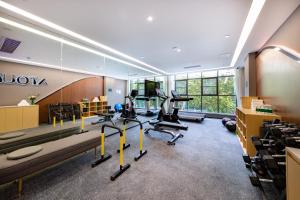 a gym with treadmills and exercise bikes in a room at Atour Hotel Shenzhen Nanshan Shili Metro Station in Shenzhen