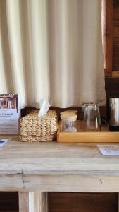 a wooden table with a basket on top of it at Kayu Cottage in Gili Trawangan