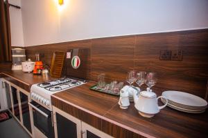 a kitchen with a stove and a counter with plates and glasses at 2BR Family Getaway Hikkaduwa- Sleep 6 - Surfing- Bikes and airport drop-off in Hikkaduwa +25 photos