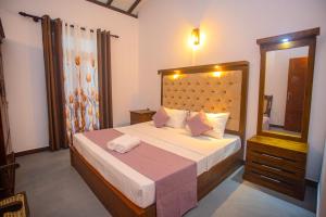 a bedroom with a large bed with a large mirror at 2BR Family Getaway Hikkaduwa- Sleep 6 - Surfing- Bikes and airport drop-off in Hikkaduwa