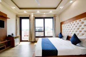 a bedroom with a large bed with a large window at Hotel Leaf 9 Boutique, Near Golf Course Road and Galleria Market in Gurgaon +82 photos