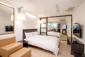 Postel nebo postele na pokoji v ubytování Guide Hotel Kaohsiung Shinkuchan