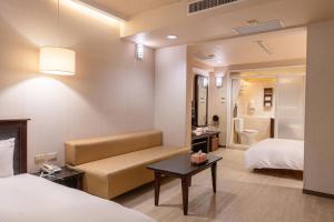 Postel nebo postele na pokoji v ubytování Guide Hotel Kaohsiung Shinkuchan