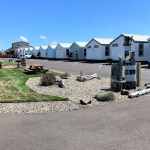 a parking lot with a park with a bench and houses at Westport Marina Cottages in Westport