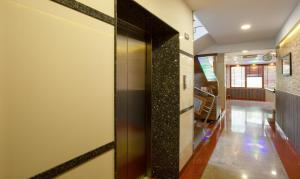 a hallway with a door in a house at Treebo The Qasr in Cochin +34 photos