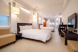 Postel nebo postele na pokoji v ubytování Guide Hotel Kaohsiung Shinkuchan