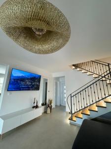 a living room with a large ceiling at Holiday home Prora Mare in Ždrelac