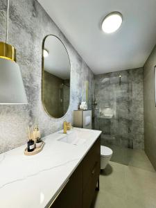 a bathroom with a sink and a toilet and a mirror at Holiday home Prora Mare in Ždrelac +29 photos