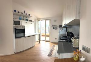 a kitchen with a sink and a stove top oven at La Terrazza di Andreina in Savona +18 photos