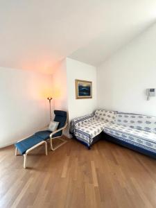 a room with two beds and a chair in it at La Terrazza di Andreina in Savona