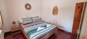 a small bedroom with a bed with two pillows at Casa Panko in Mamaia Sat/Năvodari