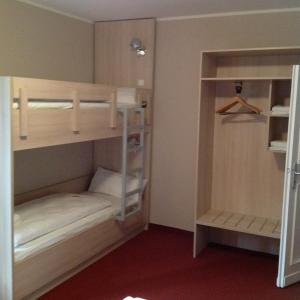 a room with two bunk beds and a closet at Rasthof & Motel Hermsdorfer Kreuz in Hermsdorf