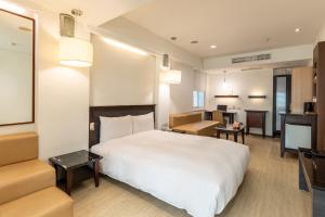 Postel nebo postele na pokoji v ubytování Guide Hotel Kaohsiung Shinkuchan