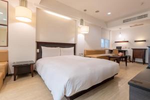 Postel nebo postele na pokoji v ubytování Guide Hotel Kaohsiung Shinkuchan