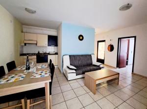 a living room with a couch and a table at Apartments Morje in Umag