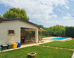 a backyard with a pavilion and a swimming pool at Apartments Morje in Umag