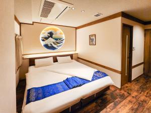 Postel nebo postele na pokoji v ubytování 都電屋 TodenHotel