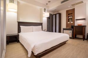 Postel nebo postele na pokoji v ubytování Guide Hotel Kaohsiung Shinkuchan