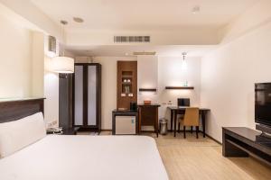 Postel nebo postele na pokoji v ubytování Guide Hotel Kaohsiung Shinkuchan