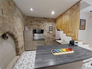 a kitchen with a counter with some paint on it at Maison centre historique Figeac in Figeac