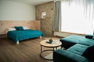 a bedroom with a bed and a couch and a table at Main Landhaus in Nordheim +15 photos