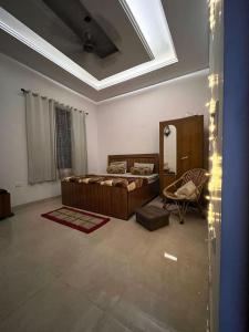 a room with a bed and a chair in it at Modern Nest Retreat in Dehradun +19 photos