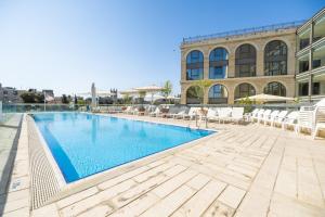 a swimming pool in front of a building at Grand Court Hotel in Jerusalem