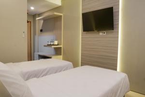 Krevet ili kreveti u jedinici u okviru objekta Sajiwa Inn and Suite Hotel