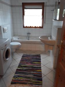 a bathroom with a tub and a toilet and a sink at Zum Harzblick in Seesen