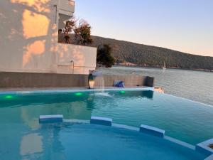 a large swimming pool with a water fountain at ALOHA Beach front Vacation Rental in Ulcinj