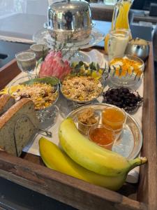 a tray with a banana and a bunch of food at Kaitahi Lodge in Palmerston North