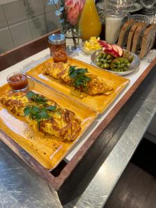 two plates of food sitting on a counter with food at Kaitahi Lodge in Palmerston North