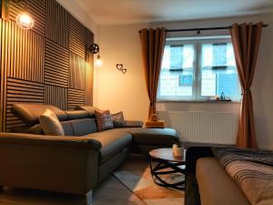 a living room with a couch and a window at FeWo Runa in Masserberg