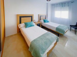 a bedroom with two beds and a window at Mar Menor Paradise by Los Pinos Holidays in San Pedro del Pinatar +24 photos