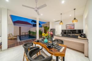 a kitchen and living room with a table and chairs at Kubung 2 - NEW listing Promo - Canggu - Big Pool and Kitchen in Kerobokan