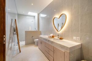 a bathroom with a sink and a mirror on the wall at Kubung 2 - NEW listing Promo - Canggu - Big Pool and Kitchen in Kerobokan
