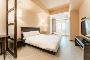 Postel nebo postele na pokoji v ubytování Guide Hotel Kaohsiung Shinkuchan