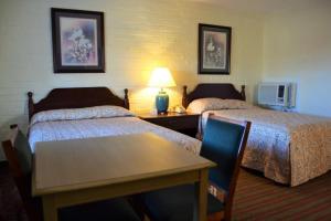 Ein Bett oder Betten in einem Zimmer der Unterkunft Motel Jesup