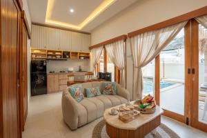 a living room with a couch and a table at Villa Tropical Terrazzo 2BR Private Pool in Jimbaran