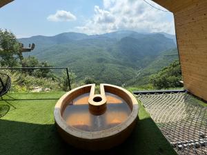 a wooden tub sitting on top of a balcony with a view at Lost in Sky in Yenokavan