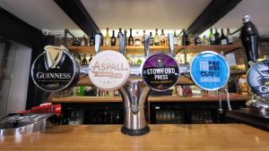 a bunch of signs on the counter of a bar at Unicorn Inn in Deddington