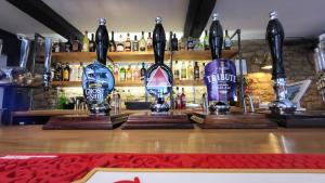 a bar with two trophies on top of a counter at Unicorn Inn in Deddington