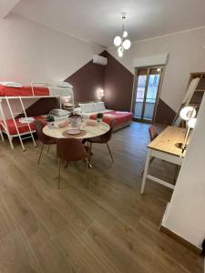 a room with a room with bunk beds and a table at B&B Elegance in Villa San Giovanni