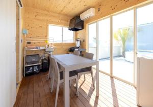 a kitchen with a table and chairs in a tiny house at Sugar Beach Oarai in Oarai