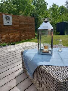 a table with a glass jar on top of a picnic table at Lodge au vent in Savigné-lʼÉvêque