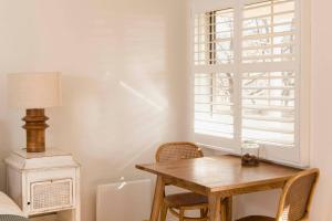 a dining room with a wooden table and a window at Peony Farm Green Cottage in Stanley