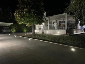 a house with a tree in front of it at night at Forte dei marmi casa vacanza in Forte dei Marmi