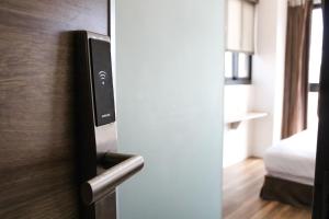 a door to a room with a bed in a room at CHECK inn Express Taichung FuXing Hall 2 in Taichung