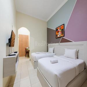 Voodi või voodid majutusasutuse Hotel 78 Parapat Mitra RedDoorz toas