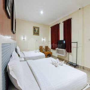 Voodi või voodid majutusasutuse Hotel 78 Parapat Mitra RedDoorz toas